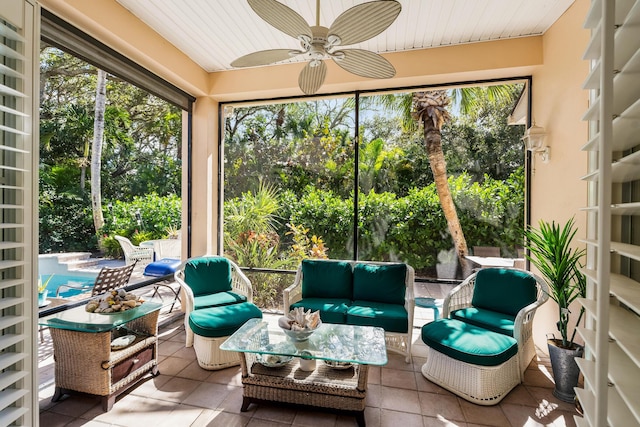 sunroom featuring ceiling fan