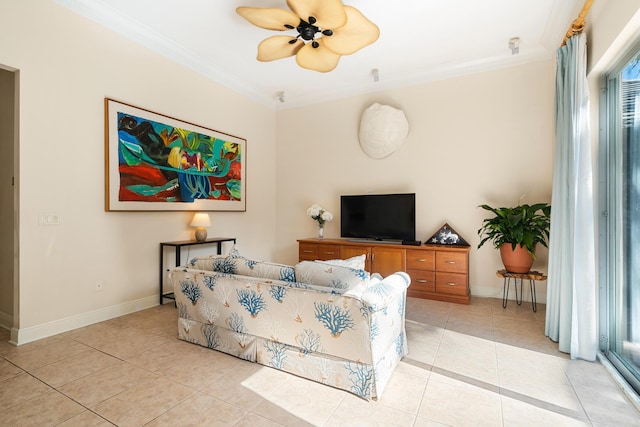 living room with ceiling fan, ornamental molding, and light tile patterned floors