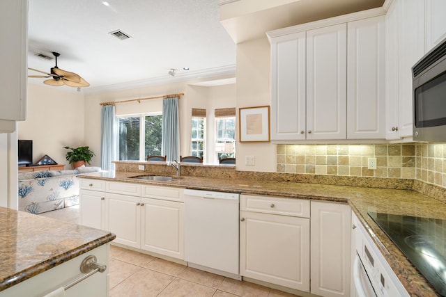 kitchen with sink, white cabinetry, dark stone countertops, dishwasher, and kitchen peninsula