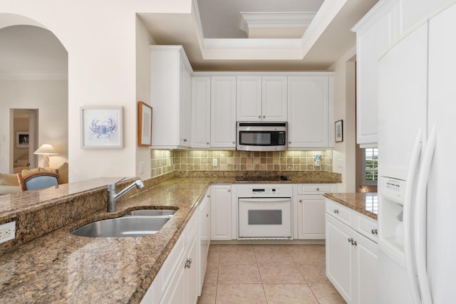 kitchen featuring white cabinetry, sink, stone countertops, and white appliances