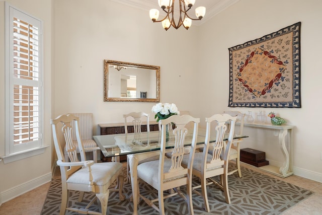 dining area featuring tile patterned flooring, crown molding, and a chandelier