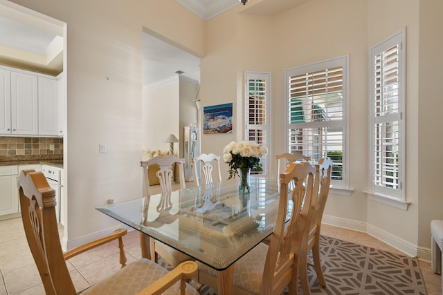 dining room with crown molding, a healthy amount of sunlight, and light tile patterned floors