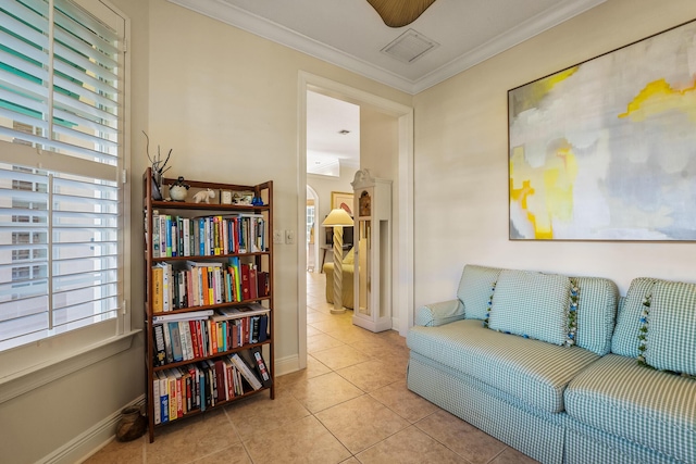 sitting room featuring light tile patterned flooring, ornamental molding, and ceiling fan