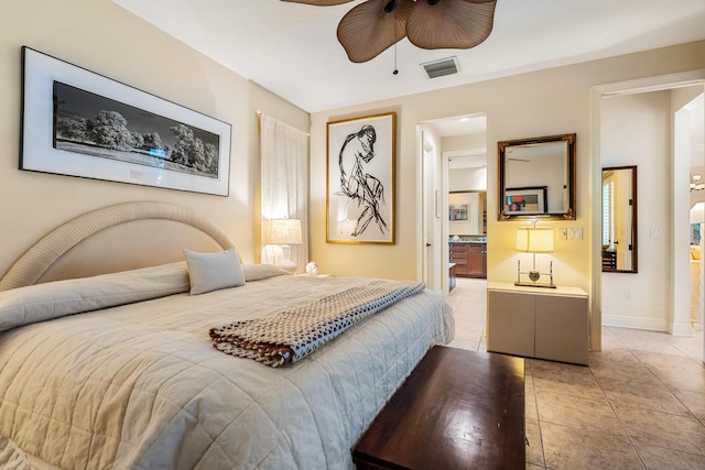 tiled bedroom with ceiling fan and ensuite bath