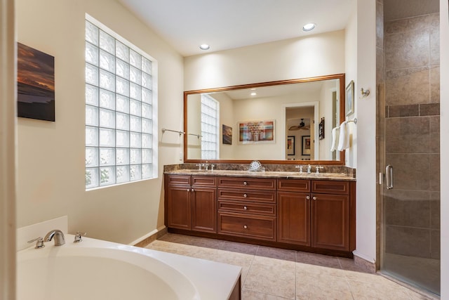 bathroom with vanity, tile patterned floors, and plus walk in shower