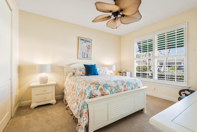 carpeted bedroom featuring ceiling fan and a closet