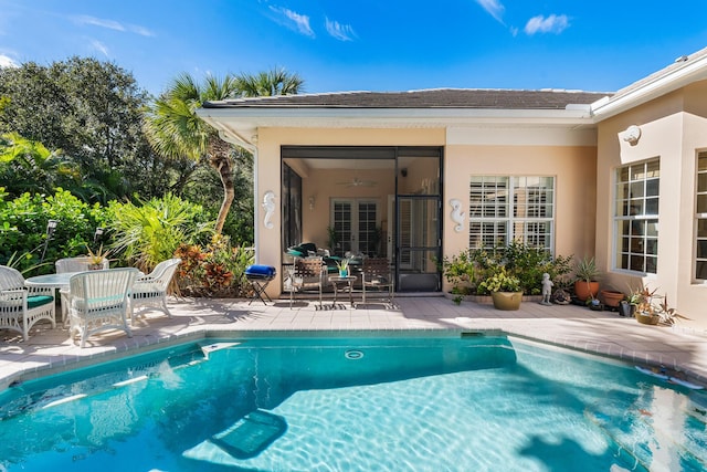 view of swimming pool with a patio area and ceiling fan