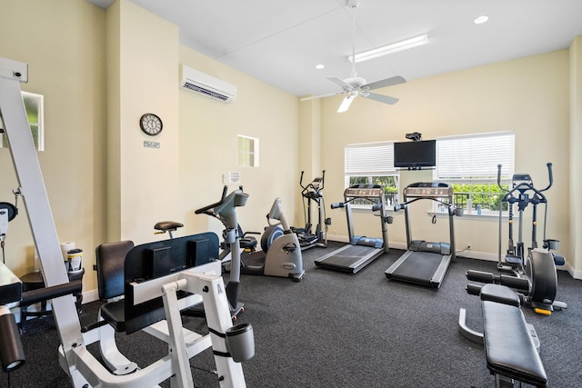 exercise room featuring ceiling fan and a wall unit AC