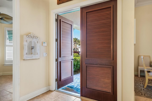 tiled entryway with ceiling fan