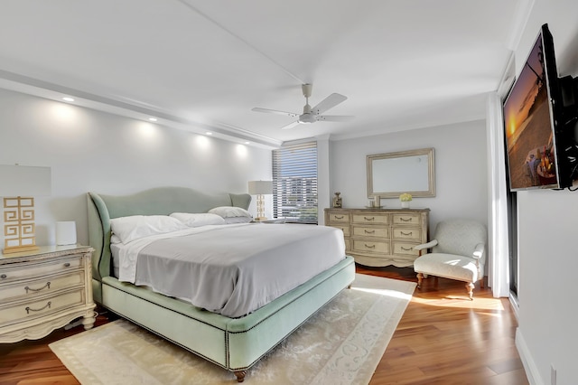 bedroom with ceiling fan and light hardwood / wood-style floors