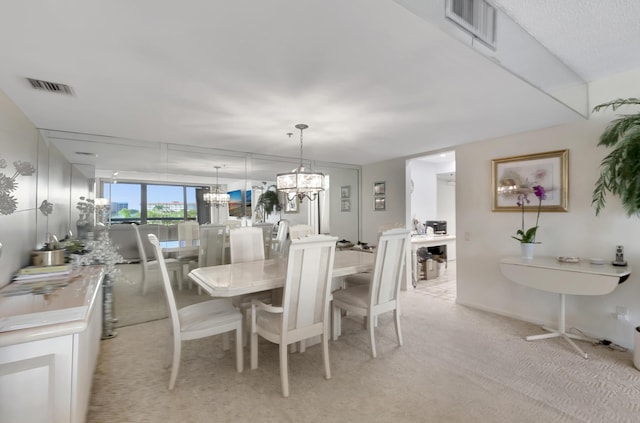 dining room featuring light colored carpet and a notable chandelier