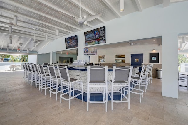 interior space with beamed ceiling, ceiling fan, wooden ceiling, and high vaulted ceiling