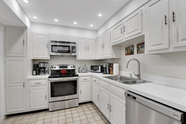 kitchen featuring stainless steel appliances, sink, and white cabinets