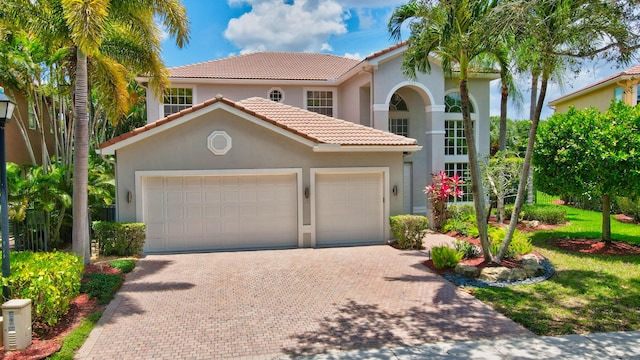 mediterranean / spanish-style home with a garage