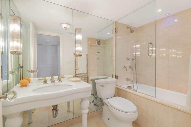 full bathroom with enclosed tub / shower combo, tile patterned floors, toilet, and sink