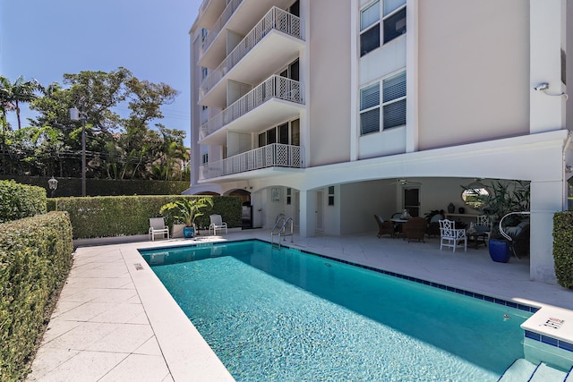 view of swimming pool featuring a patio area