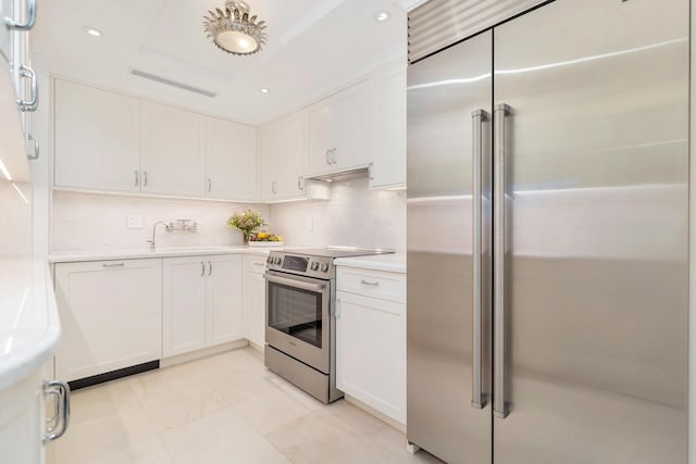 kitchen with white cabinetry, backsplash, sink, and appliances with stainless steel finishes