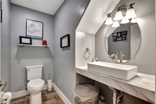 bathroom featuring sink, hardwood / wood-style floors, and toilet