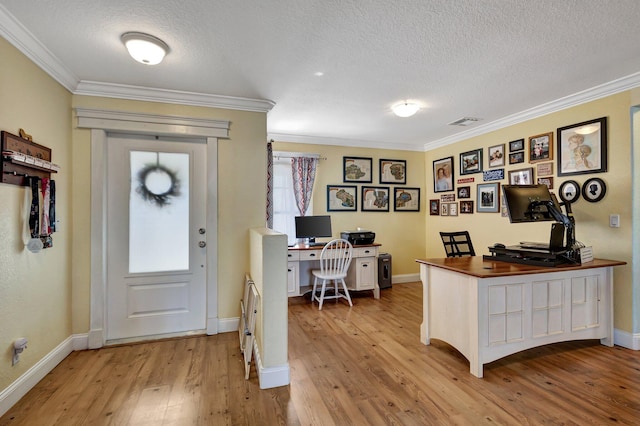 office with ornamental molding, a textured ceiling, and light hardwood / wood-style floors