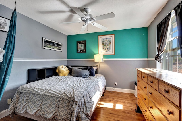 bedroom featuring light hardwood / wood-style flooring and ceiling fan