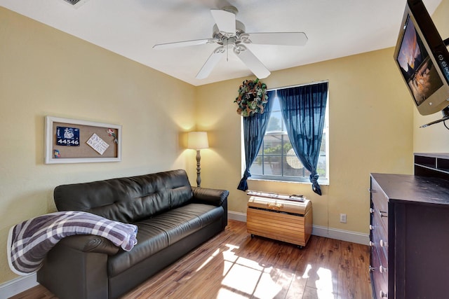 living room with ceiling fan and light hardwood / wood-style floors