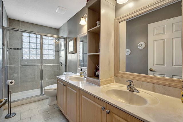 bathroom with vanity, an enclosed shower, tile patterned flooring, and toilet