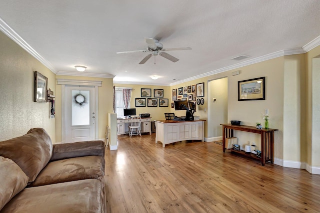 living room with crown molding, wood-type flooring, and ceiling fan