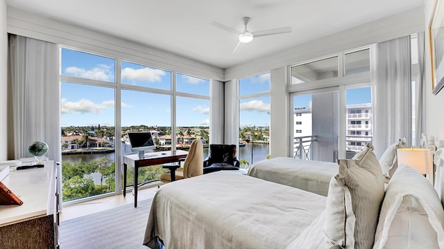 bedroom featuring access to outside and a water view