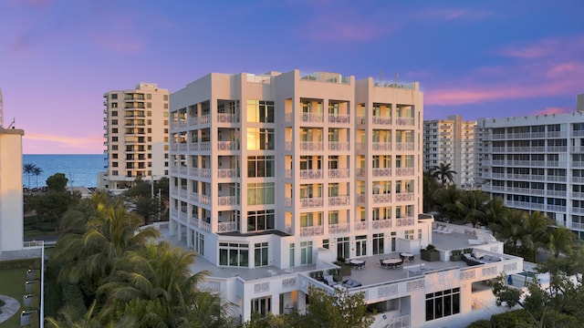 outdoor building at dusk featuring a water view