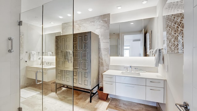 bathroom with vanity, tile walls, and walk in shower