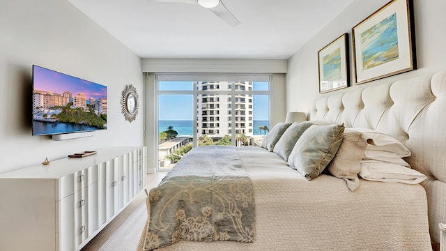 bedroom featuring hardwood / wood-style flooring, ceiling fan, and access to exterior