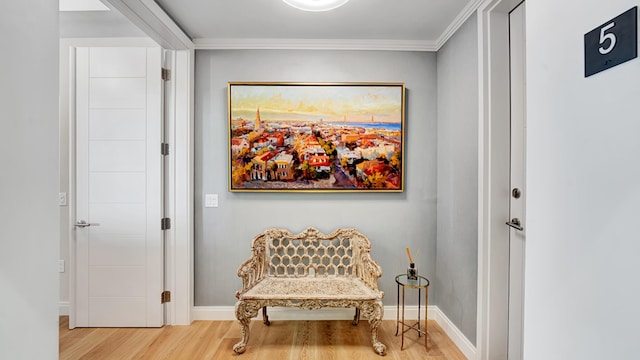 living area featuring hardwood / wood-style flooring and crown molding