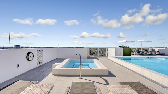 view of pool featuring a community hot tub and a patio area