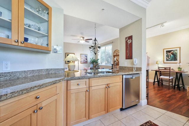 kitchen featuring sink, light stone counters, light tile patterned floors, ornamental molding, and dishwasher