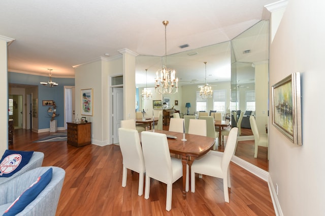 dining room featuring an inviting chandelier, hardwood / wood-style flooring, and ornamental molding