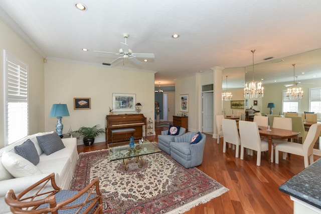 living room with crown molding, ceiling fan with notable chandelier, and hardwood / wood-style floors