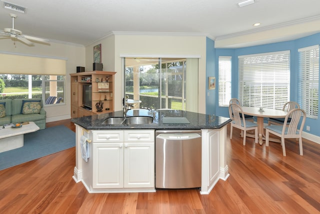 kitchen featuring sink, dishwasher, a kitchen island with sink, white cabinets, and light wood-type flooring