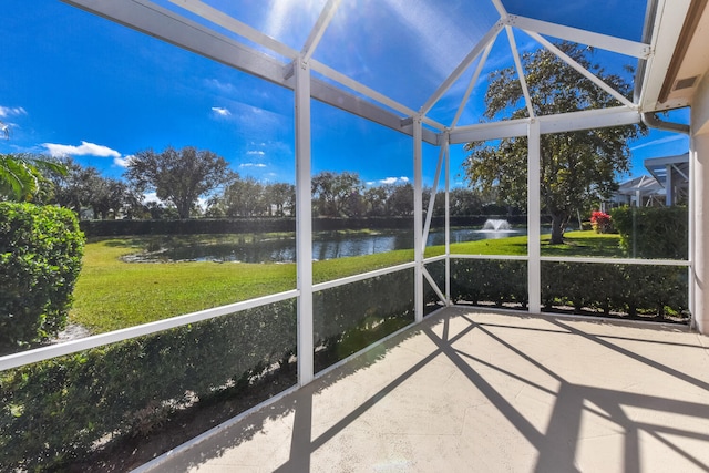 unfurnished sunroom featuring vaulted ceiling and a water view