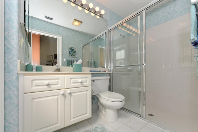 bathroom featuring tile patterned flooring, vanity, an enclosed shower, and toilet