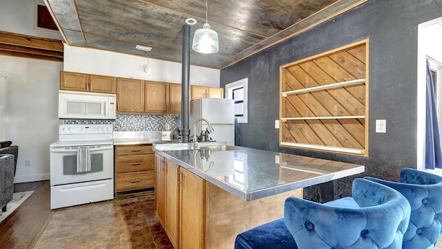 kitchen with a kitchen bar, sink, pendant lighting, white appliances, and backsplash