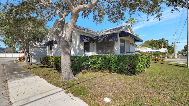 view of property exterior with a yard