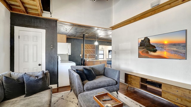 living room featuring washer / clothes dryer and light hardwood / wood-style floors