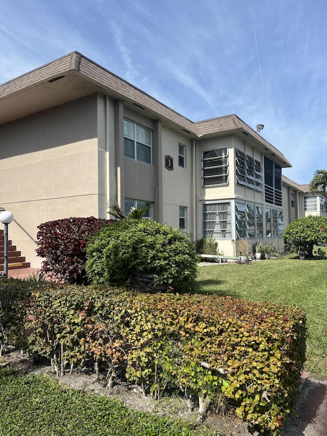 view of side of property with a yard