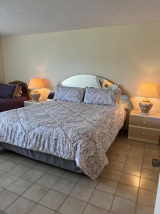 tiled bedroom with a textured ceiling