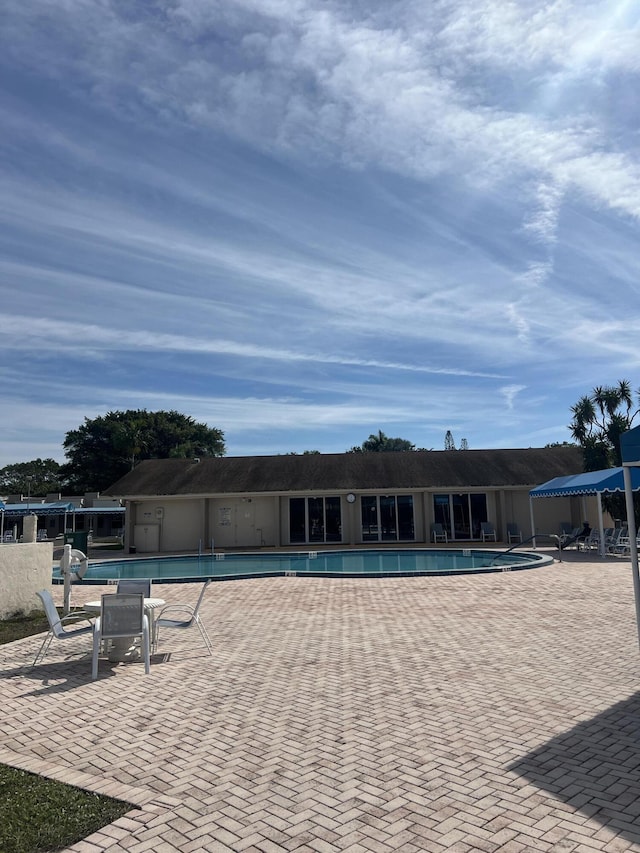 view of swimming pool featuring a patio