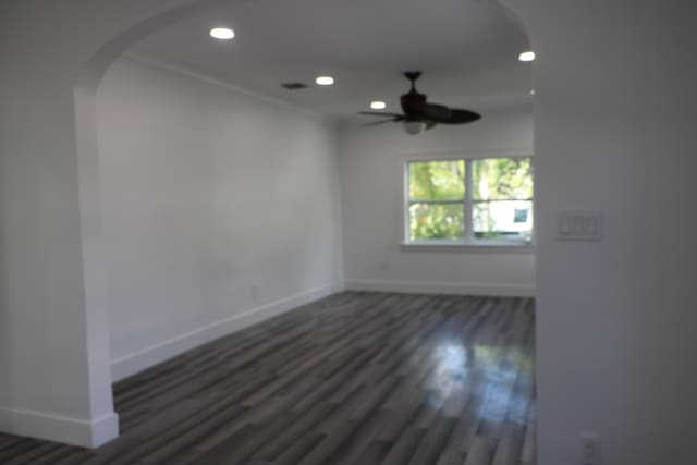 spare room featuring ceiling fan, ornamental molding, and dark hardwood / wood-style floors