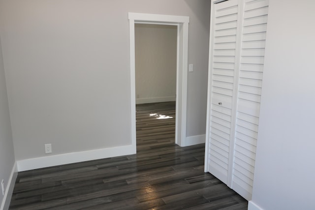 hallway with dark hardwood / wood-style floors