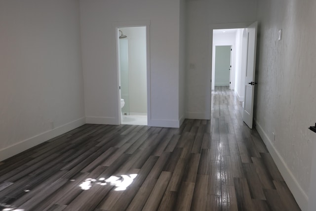 unfurnished room with dark wood-type flooring