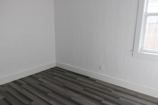 empty room featuring dark wood-type flooring