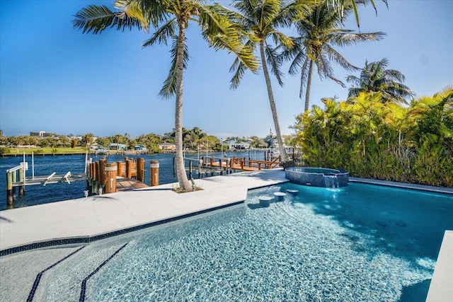 view of pool with an in ground hot tub, a water view, and a boat dock